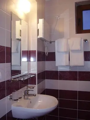 a bathroom with a sink and a mirror and towels at Grand Monastery Pamporovo Apartment 5B23 in Pamporovo