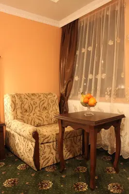 a living room with a chair and a table at Stoichkovata Kashta Koprivshtitsa in Koprivshtitsa