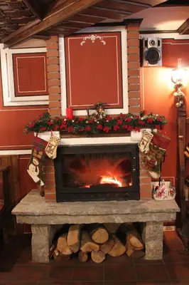 a fireplace in a room with a christmas mantle at Stoichkovata Kashta Koprivshtitsa in Koprivshtitsa
