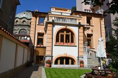 a large house with a lawn in front of it at Guest House Secession Style in Sofia