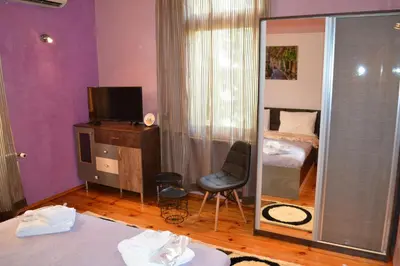 a room with a mirror and a bedroom with a bed at Guest House Secession Style in Sofia