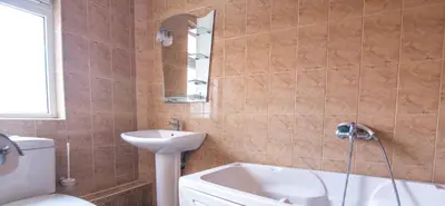 a bathroom with a sink and a tub and a toilet at Family Hotel Victoria Gold in Mineralni Bani