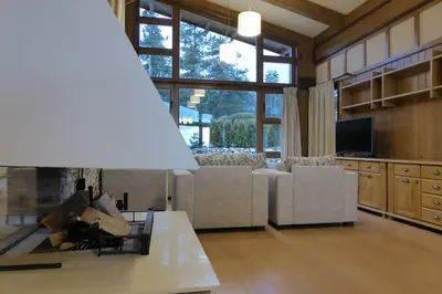 a living room with a couch and a table at Pirin Nest Villa in Bansko
