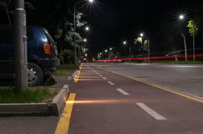 an empty street at night with a van parked on the side at Apartment Elegant in Velingrad