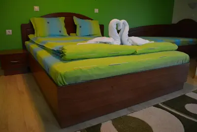 a bedroom with a bed with towel animals on it at Guest House H Dzhogolanov in Koprivshtitsa
