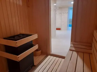a sauna with a shower and a glass door at Eco Hotel Momata in Kolarovo