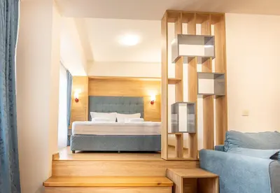 a bedroom with a bed and a mirror at Eco Hotel Momata in Kolarovo
