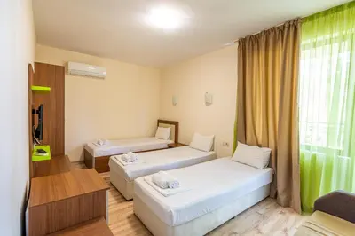 a hotel room with two beds and a window at Eco Hotel Momata in Kolarovo