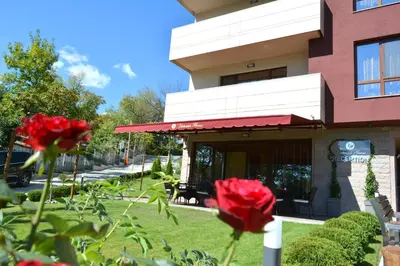 a building with red roses in front of it at Victoriya's House in Hisarya
