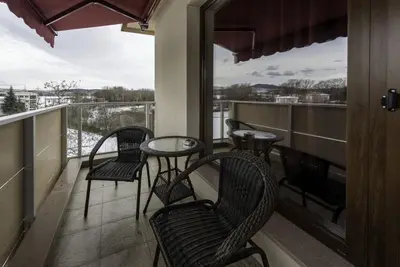 a balcony with four chairs and a table on a balcony at Victoriya's House in Hisarya
