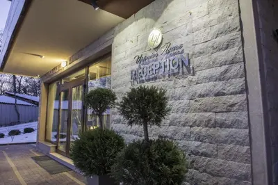 a building with a sign on the side of it at Victoriya's House in Hisarya