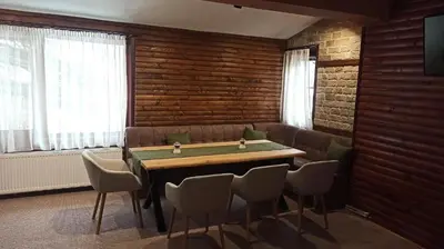 a dining room with a table and chairs at Guest House Diva Reka in Beli Iskar