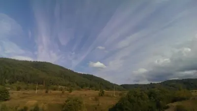 a view of a field with trees and a sky at Guest House Diva Reka in Beli Iskar