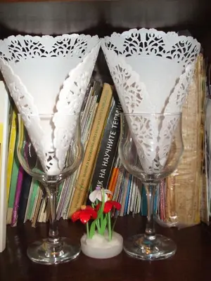two wine glasses sitting on a table with books at Kamigs Rooms in Sofia