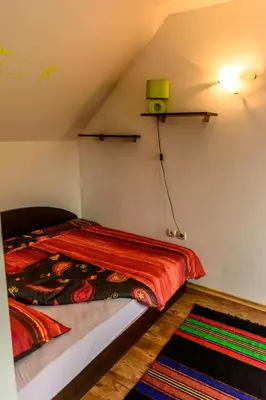 a bedroom with a bed with a red blanket at Apartment Leonardo Da Vinci in Plovdiv