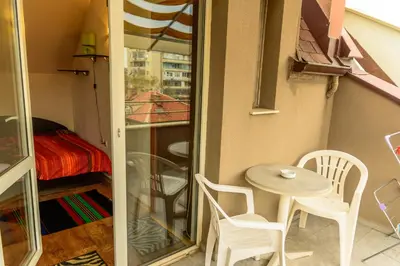 a small room with a table and chairs and a bedroom at Apartment Leonardo Da Vinci in Plovdiv