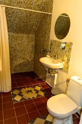 a bathroom with a toilet and a sink at Apartment Leonardo Da Vinci in Plovdiv