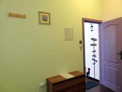 a room with a door and a cross on the wall at Like Home Guest Rooms in Sofia