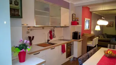 a kitchen with white cabinets and a counter top at Parkview Apartments in Sofia