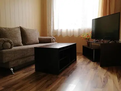 a living room with a couch and a flat screen tv at Camping Verila in Sapareva Banya
