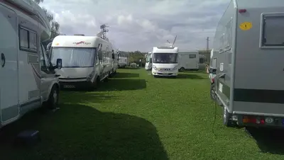a group of rvs parked in a grass field at Camping Verila in Sapareva Banya