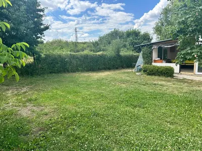 a yard with a house and a field of grass at Camping Verila in Sapareva Banya