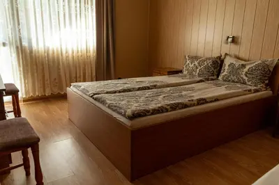 a large bed in a room with a window at Camping Verila in Sapareva Banya