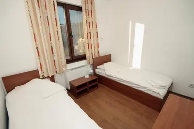 a small room with two beds and a window at Yan BibiYan Guest House in Negushevo