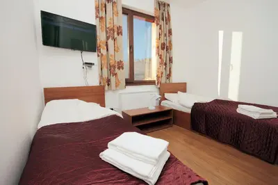 a hotel room with two beds and a window at Yan BibiYan Guest House in Negushevo