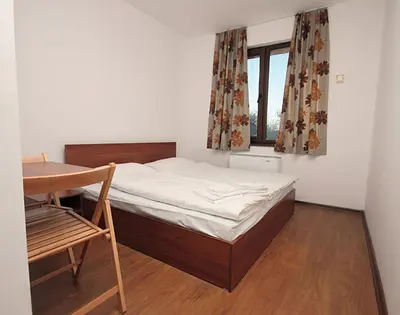 a bedroom with a bed and a desk and a window at Yan BibiYan Guest House in Negushevo