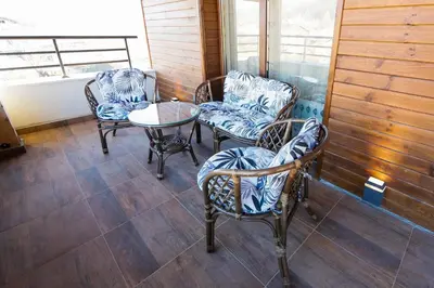a porch with chairs and a table and a window at Twin House in Ognyanovo