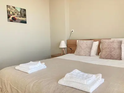 two white towels on a bed in a room at Къща за гости Мегдана in Sopot
