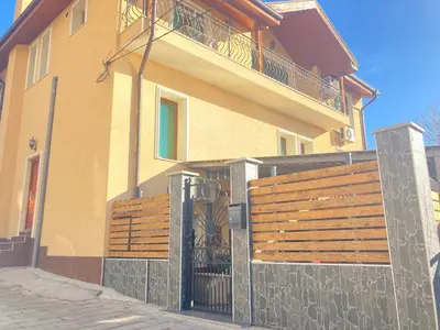 a house with a wooden fence in front of it at Къща за гости Мегдана in Sopot