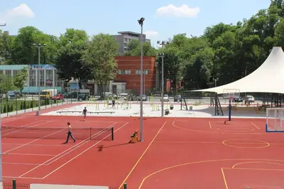 a group of people playing tennis on a tennis court at Youth Centre Plovdiv in Plovdiv