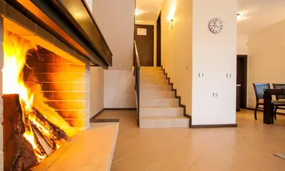 a hallway with a fireplace and a staircase at Къщи за гости КООП Добринище - Holiday Villages COOP Dobrinishte in Dobrinishte