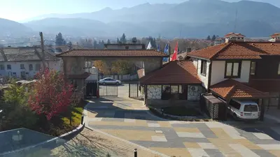 an aerial view of a small town with buildings at Къщи за гости КООП Добринище - Holiday Villages COOP Dobrinishte in Dobrinishte
