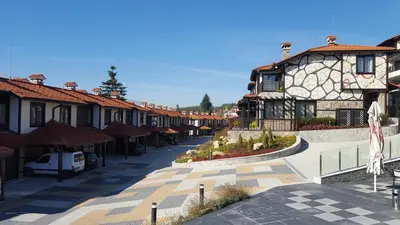 a street in a town with a building at Къщи за гости КООП Добринище - Holiday Villages COOP Dobrinishte in Dobrinishte