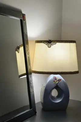 a lamp with a blue wheel next to a mirror at Hotel Hello Hissar in Hisarya
