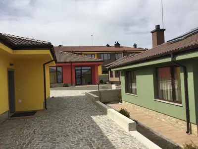 a group of houses with a cobblestone street at Guest House Colori in Tsigov Chark