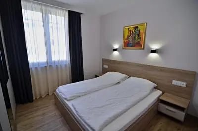 a bedroom with a bed and a window at Guest House Colori in Tsigov Chark