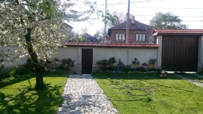 a house with a garden with a hose at Bobekova Kashta in Panagyurishte