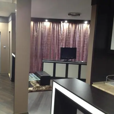 a living room with a television and pink curtains at Studio Mountain Dreams Deluxe in Sapareva Banya