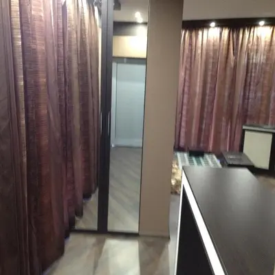 a room with curtains and a table and a mirror at Studio Mountain Dreams Deluxe in Sapareva Banya