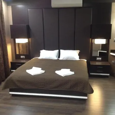a bedroom with a large bed with two pillows on it at Studio Mountain Dreams Deluxe in Sapareva Banya
