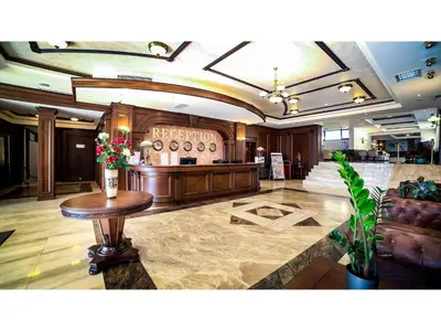 a lobby with a table with flowers on it at Park Hotel and SPA Vella Hills in Velingrad