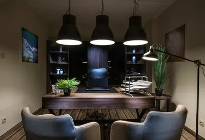 a room with a desk with chairs and lights at Premier Sofia Airport Hotel in Sofia
