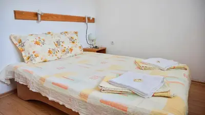 a bedroom with a bed with towels on it at Pamir Guest House in Shipkovo
