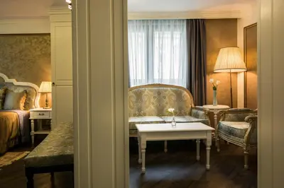 a hotel room with a couch and a table at Boutique Guest House Coco in Plovdiv
