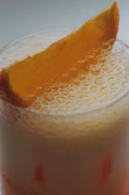 a close up of a drink with an orange slice on top at Boutique Guest House Coco in Plovdiv