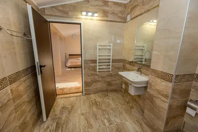 a bathroom with a sink and a shower and a mirror at Hotel Kristal in Dospat